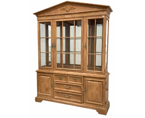 Large Georgian style light oak display cabinet/ bookcase, arched pediment centred by floral carved decoration, three glazed d