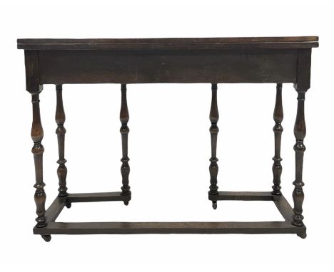 Early 20th century oak console table, the rectangular fold over top with double gate leg action, raised on turned supports wi