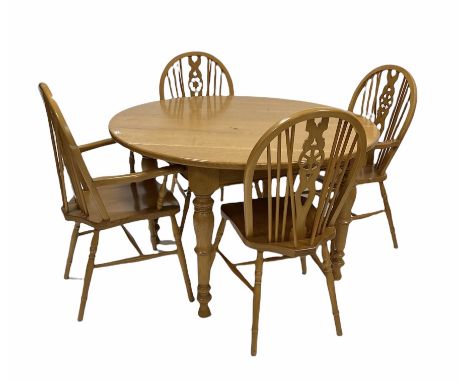 Light oak dining table, the circular top raised on turned supports (D124cm, H76cm) together with with set four (2+2) elm and 