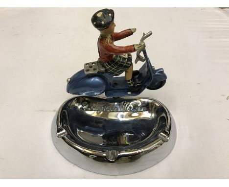 A Douglas Vespa chrome plated ashtray surmounted by a Scotsman on a Douglas Vespa scooter. Provenance: by descent given to th