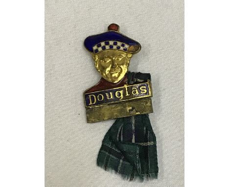 A Douglas part enamel lapel badge in the form of a Scotsman, made by H.W. Miller. Provenance as lot 449.