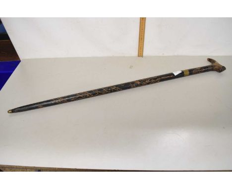 A carved ebonised sword stick