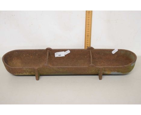 A vintage cast iron trough