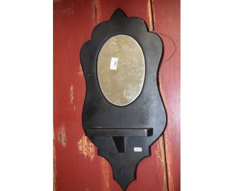 A black painted pine wall mirror and shelf