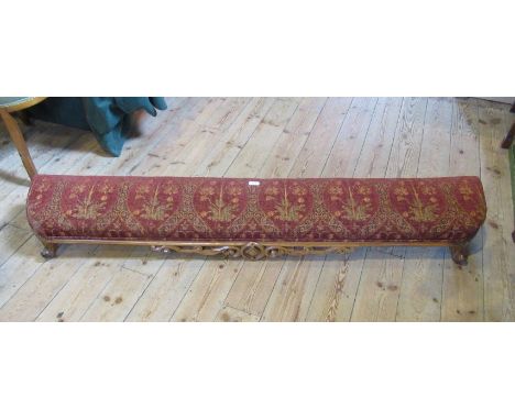 A walnut framed kneeling stool with later floral print upholstered pad, over a pierced frieze on short cabriole legs and knuc