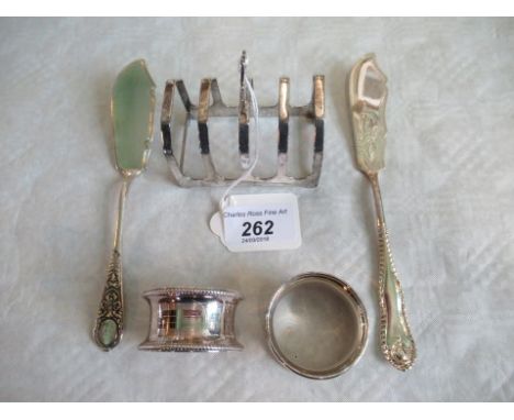 A Art Deco design silver melba toast rack with four sections, two silver napkin rings and two silver fish knives, various mak