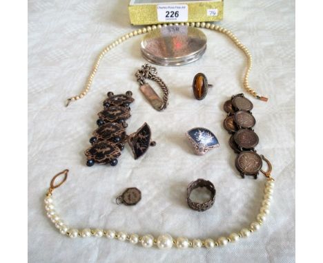 A quantity of silver jewellery of items to include: a Stuart Devlin-type neckerchief feral, identity bracelet, silver powder 