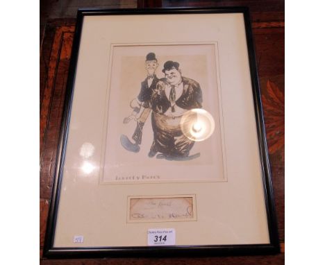 An ebonised framed and glazed reproduction print of Stan Laurel and Oliver Hardy, beneath this print the mount is cut away re