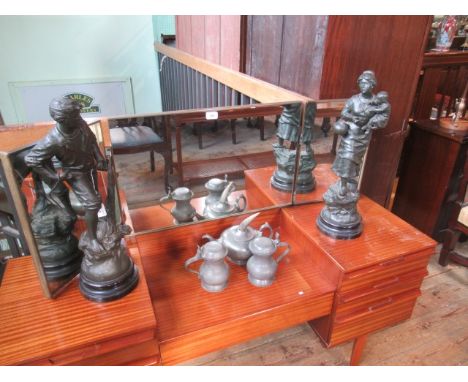 A spelter figure cast as a fisherman with net, together with another with his wife cradling their child, each on ebonised soc