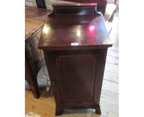 An Edwardian mahogany and boxwood strung pot cupboard, the panelled door enclosing single shelf on splayed block supports.   