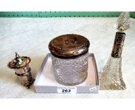 A silver topped dressing table jar, a silver collared cut glass scent bottle, a small spill vase and one other item of silver