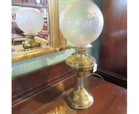 A lacquered brass oil lamp, now converted for electricity.