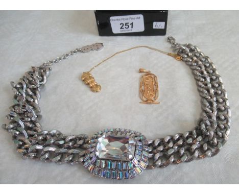 A large Egyptian-style pendant and a South American Inca-type pendant and a large stone set chain link necklace.