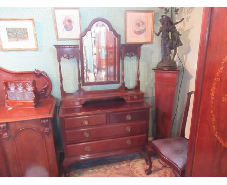 An Edwardian mahogany dressing mirror, the stepped bevelled plate flanked by a twin column support over trinket shelf and dra