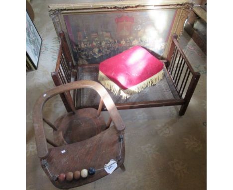 A vintage oak faced ply child's chair and red velour topped fringed footstool and folding child's cot.