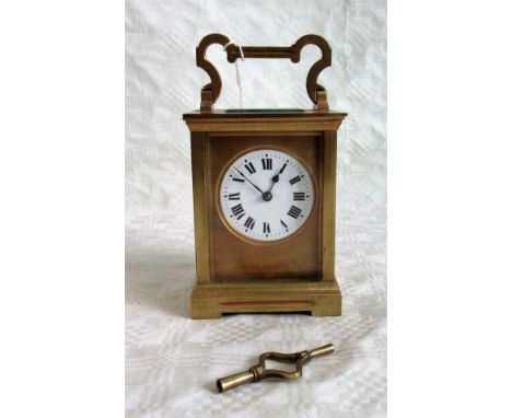 A French eight day chiming carriage clock. Condition Report: 18cms handle up.  Key with clock.  No obvious signs of damage.  
