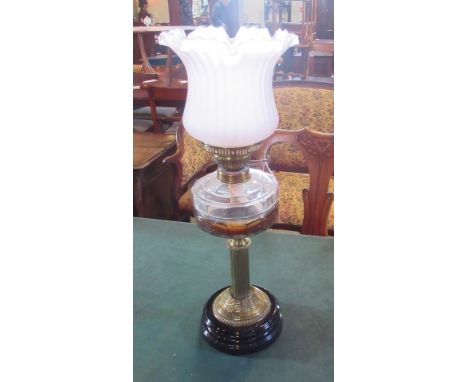 A late Victorian gilt brass and glass table oil lamp with duplex burner, frosted and frilled shade.