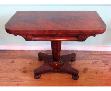 A William IV mahogany card table, the rectangular swivel fold-over top on an octagonal column, concave base and four lobed fe