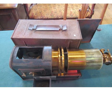 A Victorian lacquered brush and Japanned magic lantern, with acetylene burner in it's own Japanned travelling case.