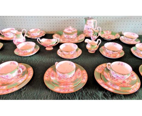 An extensive Minton bone china tea service. Condition Report: Cracks to 3 plates, 2, cups, 3 saucers, lid of sugar bowl, chip