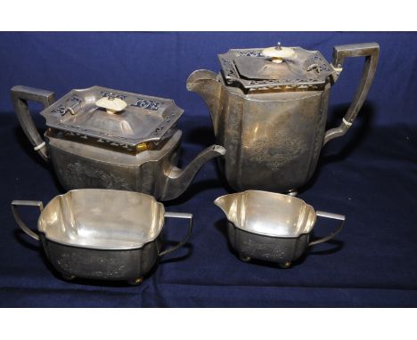 Four piece Birmingham 1906 silver hallmarked tea service with engraved scroll work and floral detail raised on bun feet with 