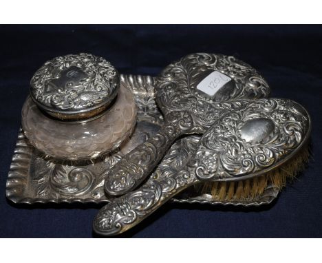 Birmingham silver hallmarked dressing table set comprising of embossed rectangular tray, hand mirror, brush and glass dressin