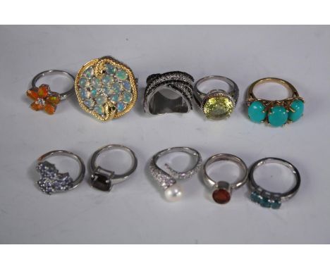 A collection of ten silver gem-set rings of various designs. Set with Fire opal, Turquoise, Tanzanite and pearl. Stamped 925.