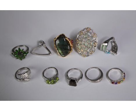 A collection of ten silver gem-set rings of various designs. Set with peridot, Labradorite, amethyst and opal. Stamped 925. V