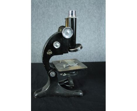 A boxed microscope made by Beck London. Model 29. Finished in black enamel. Made between circa 1925. H.35 W.17 D.23cm. (box) 
