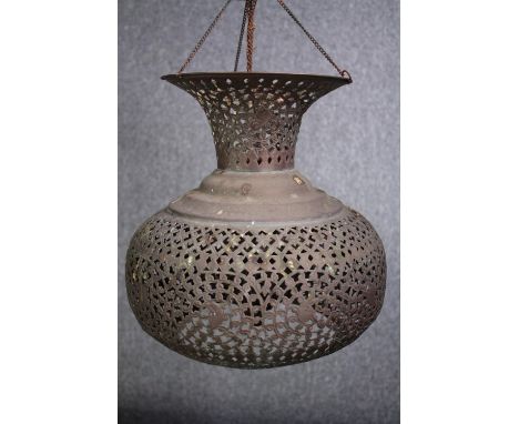 An Arabic pierced copper ceiling lantern. With a chain support. Aged with a patina. H.42cm. 