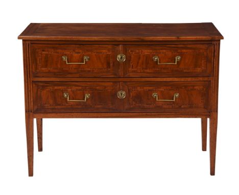 A French walnut and marquetry inlaid commode, early 19th century, with two drawers, the fluted corners leading to tapering le
