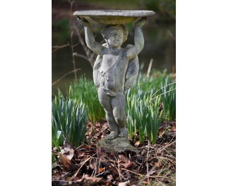 A lead figural bird bath, the basin with lobed underside held aloft by a cherub, 68cm high, 38cm diameter Provenance: From th