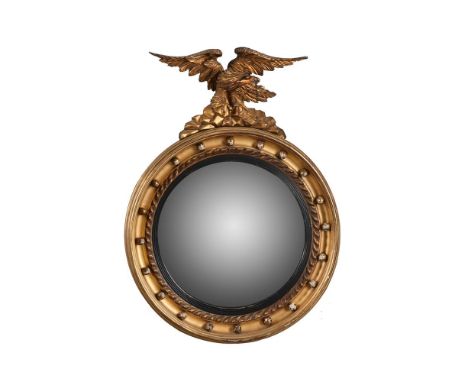 A giltwood and composition convex wall mirror in Regency style, second half 19th century,  with cavetto and ball encrusted su