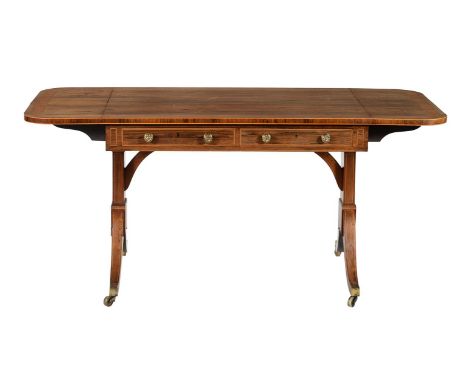 Y A Regency rosewood, banded, and crossbanded sofa table, circa 1815,  with two short drawers opposed by false drawer fronts,