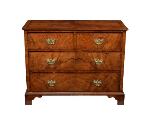 A walnut and featherbanded chest of drawers, mid 18th century and later, with arrangement of two short and two long drawers, 