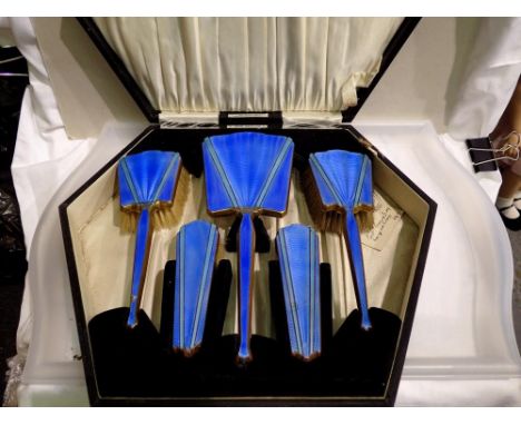 Art Deco period five piece dressing brush set with guilloche enamel backs and fitted case, damages throughout. Not available 