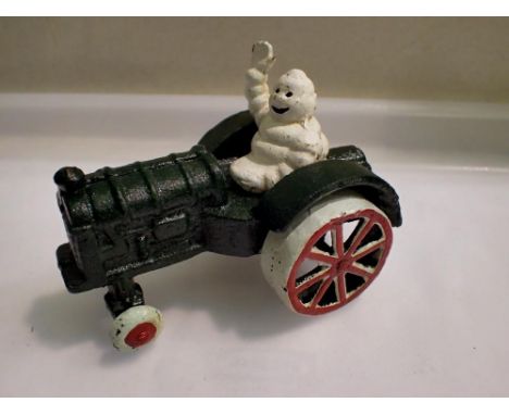 Cast iron Michelin man on tractor. H: 80mm UK P&amp;P Group 1 (£16+VAT for the first lot and £2+VAT for subsequent lots) 