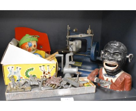 A collection of mixed Toys including Ethnic Money Box, Lead Soldiers, Vulcan Sewing Machine, Pelham WH Standard Boy Puppet an