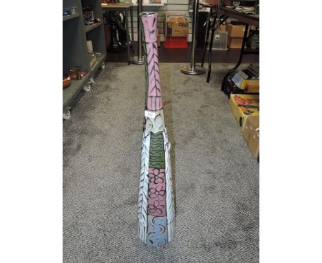 A modern bottle form vase having various colour panels and decorations