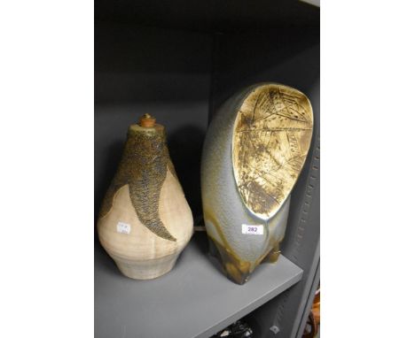 Two mid century studio pottery lamp bases one of typical design and similar slipware cast having damage to base