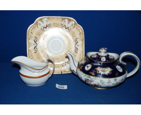 Three items of Spode China including a Teapot in cobalt blue painted with birds and butterflies circa 1913, a Creamer in 'New