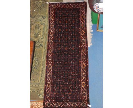 A good antique Mahal Runner from North West Persia, the indigo field having an all-over design of geometric motifs framed by 