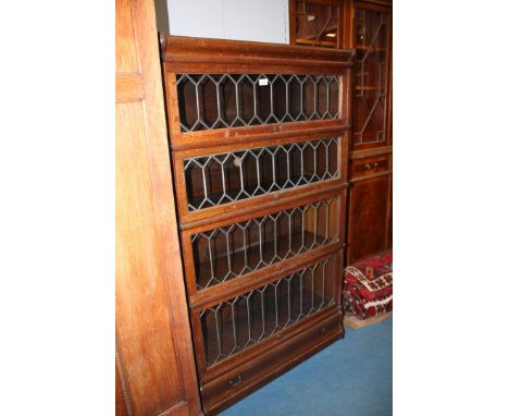A good Globe Wernicke five section Bookcase, having moulded top over the four leaded and glazed up and over doors and lower f