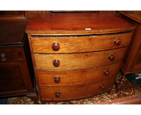 A Georgian Mahogany bow fronted Chest of four long graduated drawers having plain top over the four drawers with Oak linings,