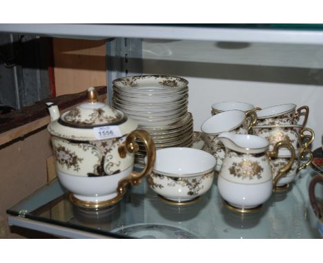 A ''Meito'' white ground Teaset with black and gilt design comprising eight Cups and saucers, Teapot, eight tea Plates, Milk 