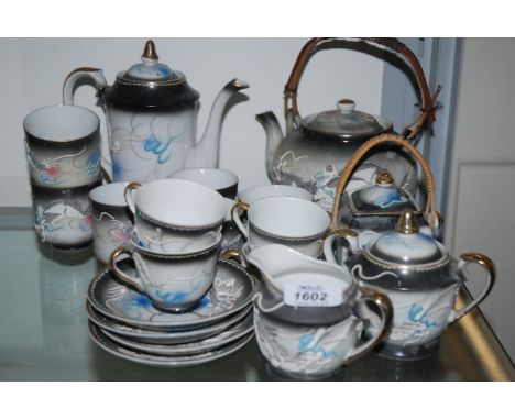 An oriental Teaset with dragon detail including four cups and saucers, (the cups having geisha girl lithophane to base), teap