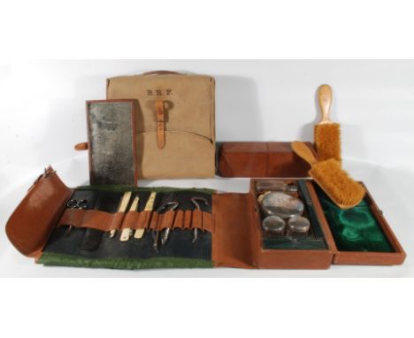 A campaign Gentleman's leather cased Vanity Set including a pair of Boot Pulls, Tweezers, Paper Knife/Scalpel, pair of cut th