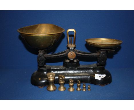 A set of brass kitchen scales and weights