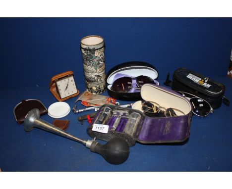 A quantity of miscellanea including a car puncture repair kit in Treacle Cookies Tin, an old car horn, a travel clock, a gent