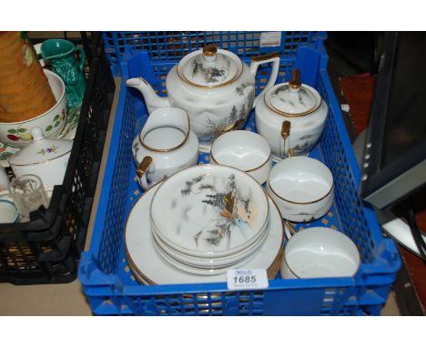 A Japanese eggshell part Teaset comprising three Cups and four saucers, Milk Jug and Sugar Bowl, etc.